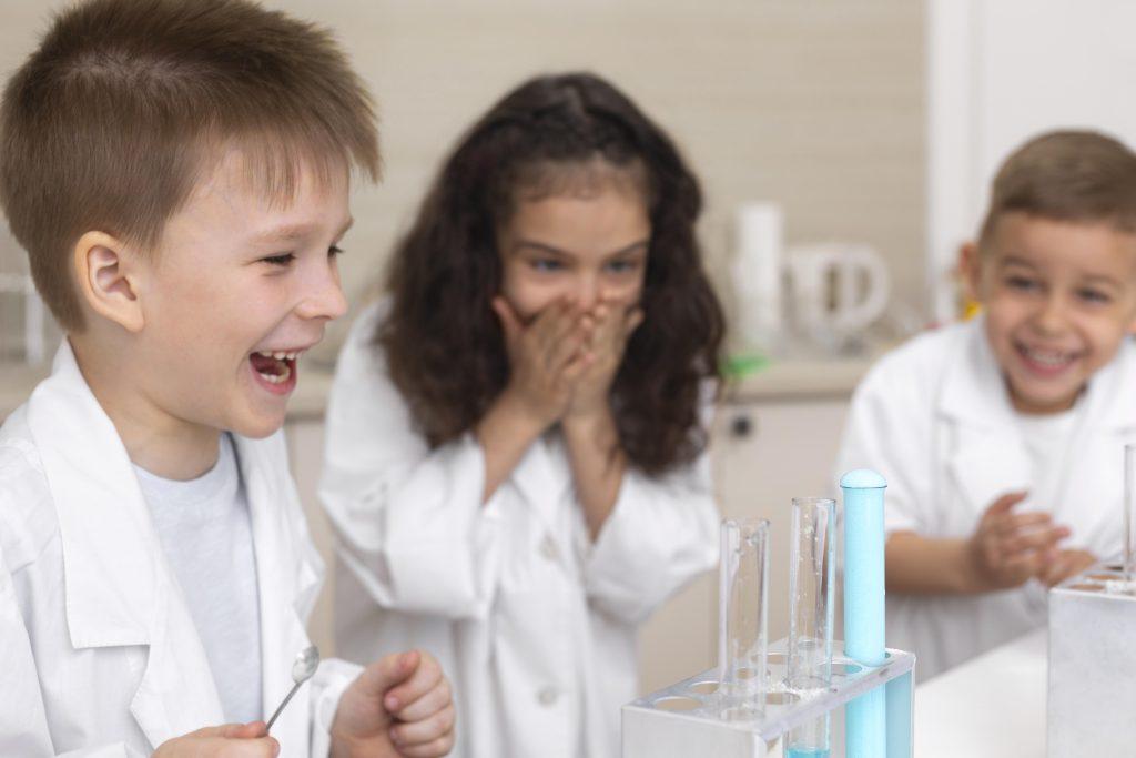 colleagues-doing-chemical-experiment-school